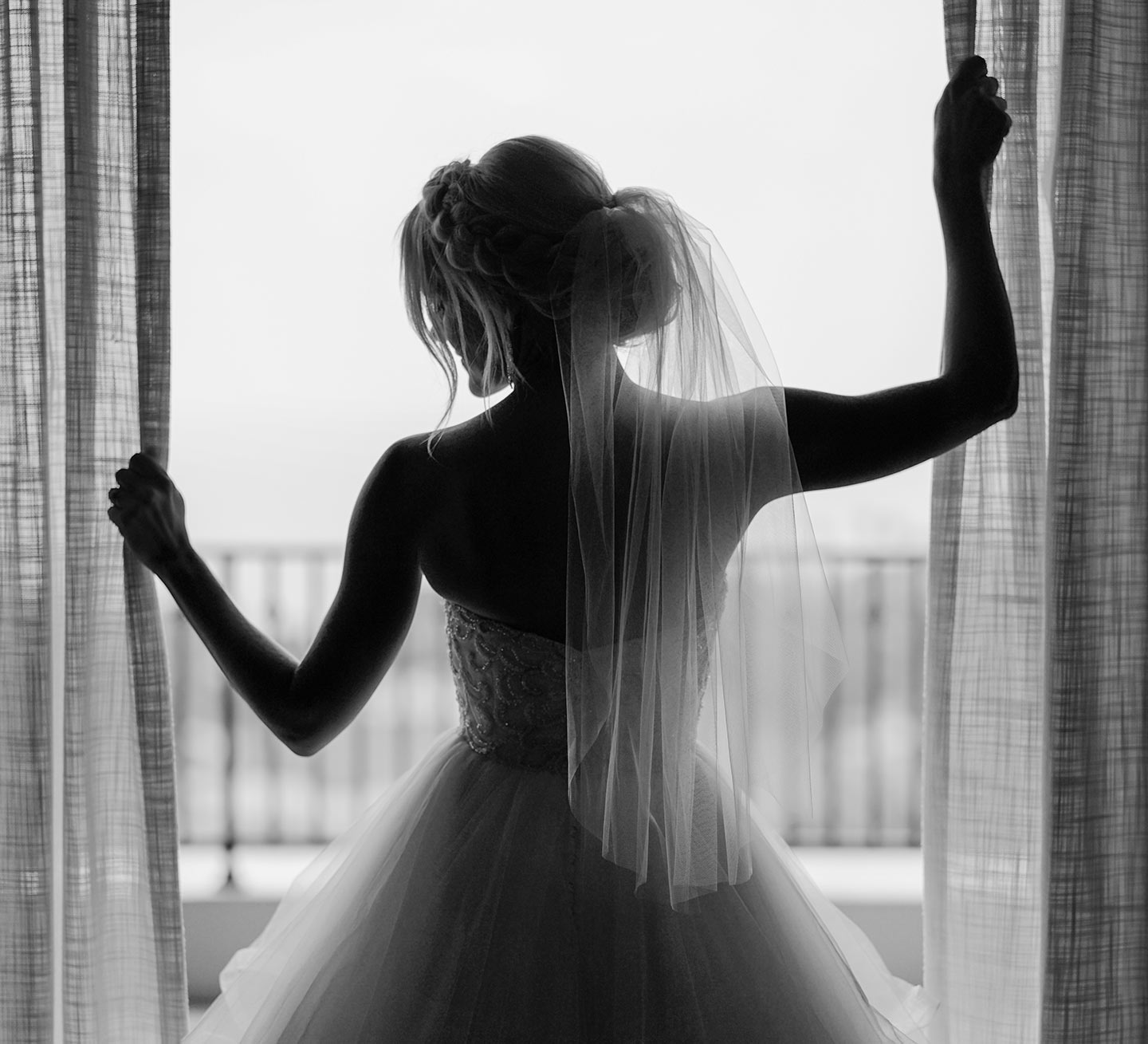 Bride in her dress at a Window